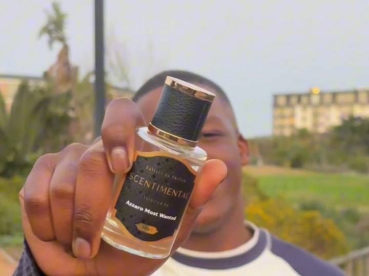 Scentimental creator holding a 50ml Scentimental Extrait de Parfum bottle